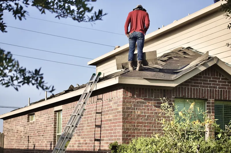 Professional roofer working on a residential roof in La Sierra